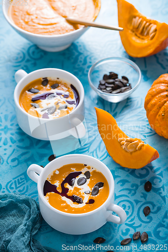 Image of Homemade pumpkin soup with coconut milk, pumpkin oil and seeds