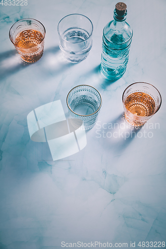 Image of Water in vintage glasses and bottle 