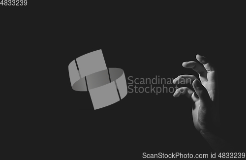 Image of Hand with light and shadow, black an white, isolated on black
