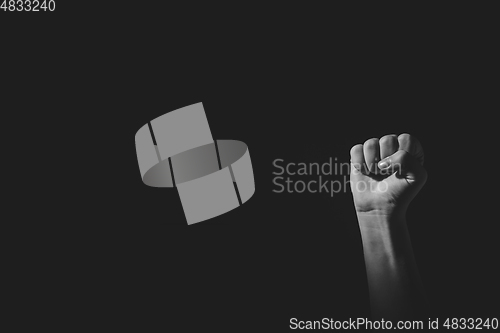 Image of Fist pose hand with light and shadow, black an white, isolated on black