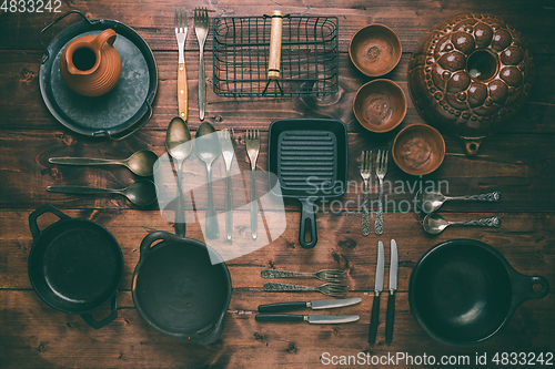 Image of Assortment of vintage kitchen utensils on wooden table