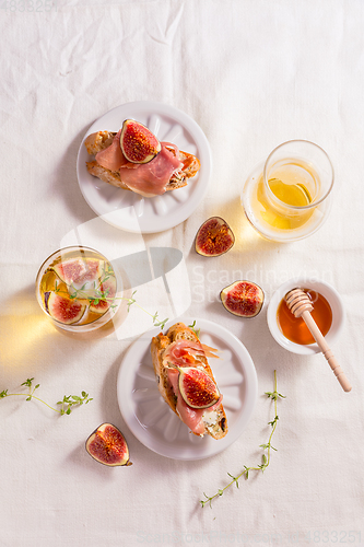 Image of Small canape snack, crostini with ham, fig and apple wine