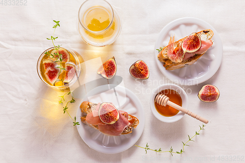 Image of Small canape snack, crostini with ham, fig and apple wine