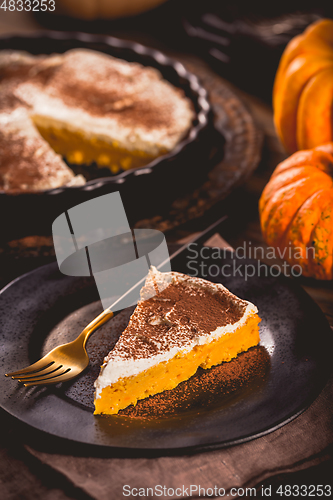 Image of Homemade pumpkin pie with icing for Thanksgiving