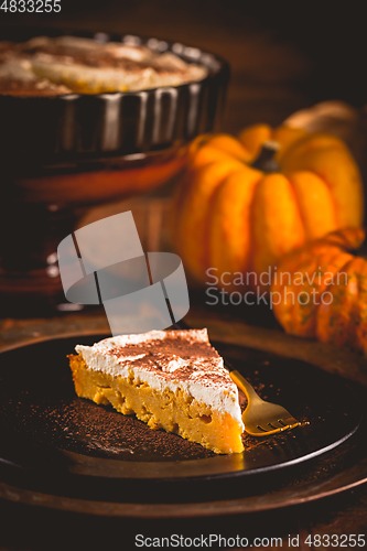 Image of Homemade pumpkin pie with icing for Thanksgiving