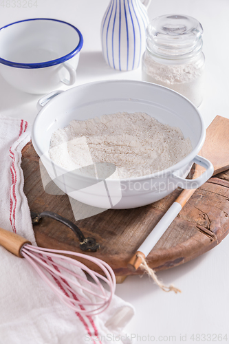 Image of Flour and egg with baking ingredients and kitchen utensils