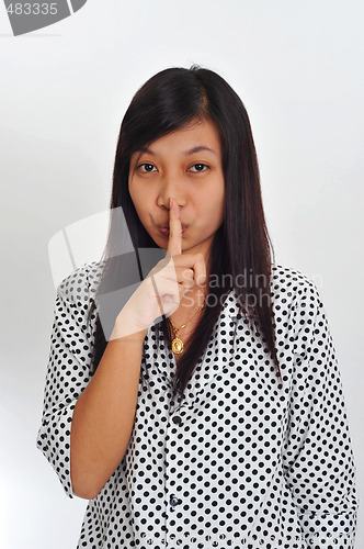 Image of young asian with finger on her lips