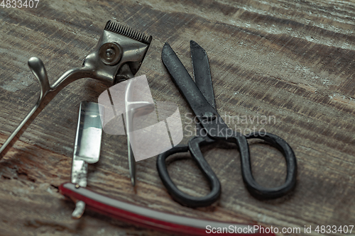 Image of Vintage steel scissors on wooden table background