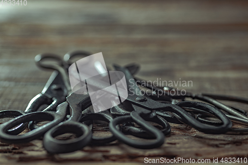 Image of Vintage steel scissors on wooden table background