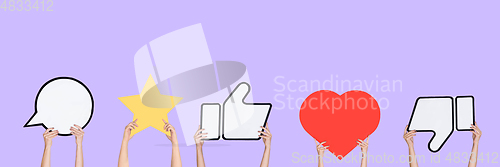Image of Hands holding the signs of social media on purple studio background, flyer