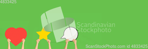 Image of Hands holding the signs of social media on green studio background, flyer