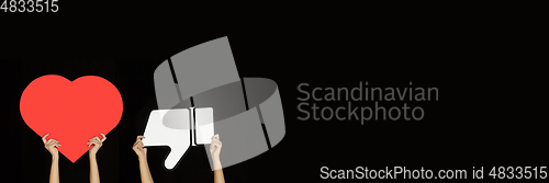 Image of Hands holding the signs of social media on black studio background, flyer