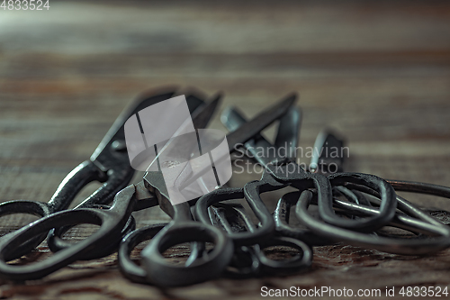 Image of Vintage steel scissors on wooden table background