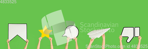 Image of Hands holding the signs of social media on green studio background, flyer