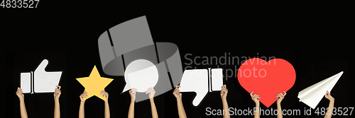 Image of Hands holding the signs of social media on black studio background, flyer