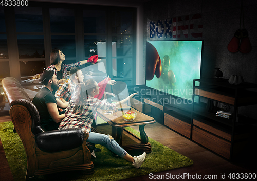 Image of Group of friends watching TV, boxing match in USA, sport games