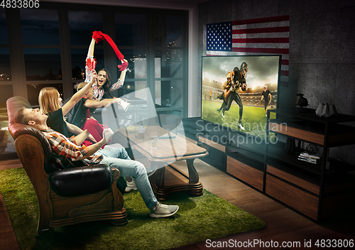 Image of Group of friends watching TV, match, sport games