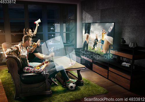 Image of Group of friends watching TV, match, sport games