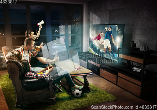 Image of Group of friends watching TV, football match, sport games