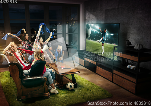 Image of Group of friends watching TV, football, soccer match, sport games