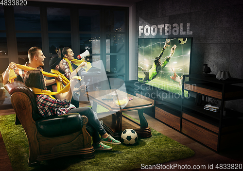 Image of Group of friends watching TV, football match, sport games