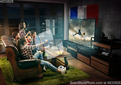 Image of Group of friends watching TV, match, sport games, football fans in France