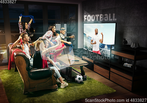 Image of Group of friends watching TV, football, soccer match, sport games