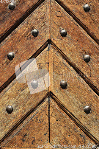 Image of Fragment of old wooden doors with metal rivets