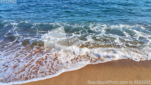 Image of Sea water with white foam in the coastal sand