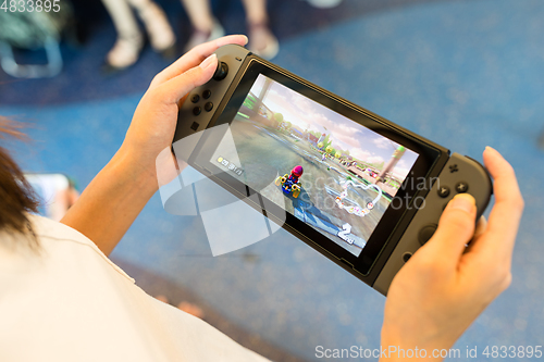 Image of Hong Kong, 19 May 2017 -:Woman Playing mario kart 8 on Nintendo 