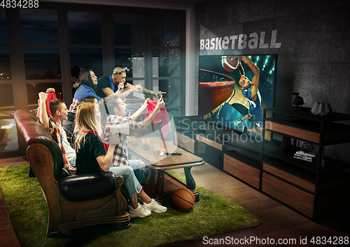 Image of Group of friends watching TV, basketball match, sport games