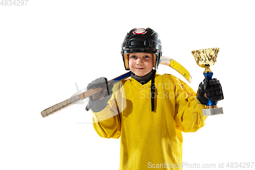 Image of Little hockey player with the stick on ice court and white studio background