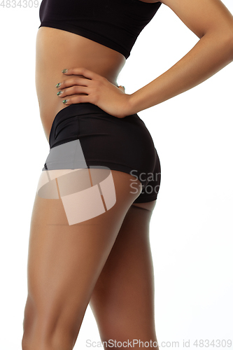 Image of Slim tanned woman\'s body isolated on white studio background