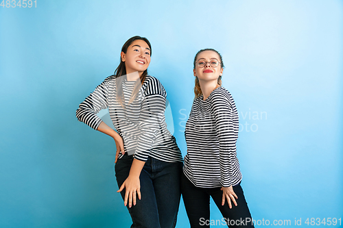 Image of Young emotional women on gradient blue background