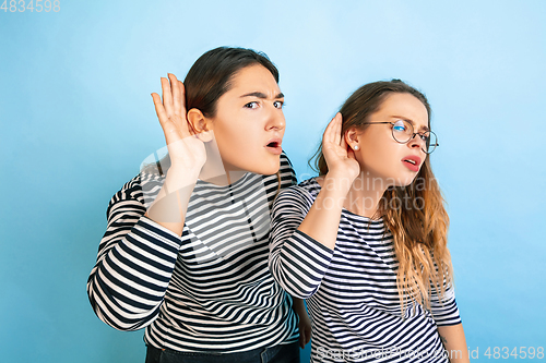 Image of Young emotional women on gradient blue background