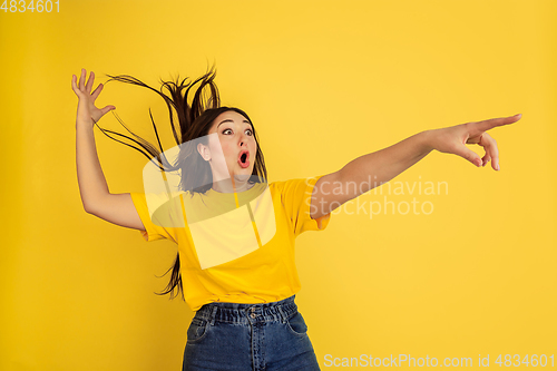 Image of Caucasian woman\'s portrait isolated on yellow studio background