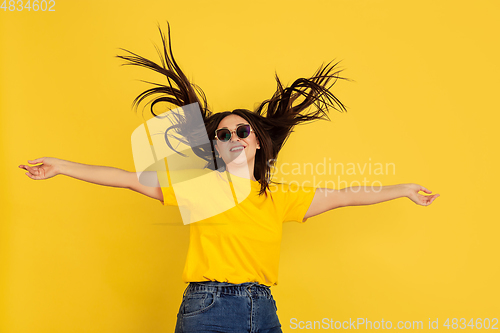 Image of Caucasian woman\'s portrait isolated on yellow studio background