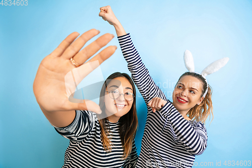 Image of Young emotional women on gradient blue background