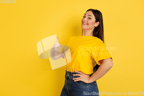 Image of Caucasian woman\'s portrait isolated on yellow studio background