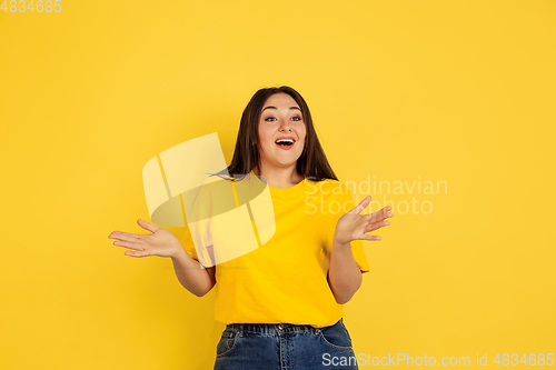 Image of Caucasian woman\'s portrait isolated on yellow studio background