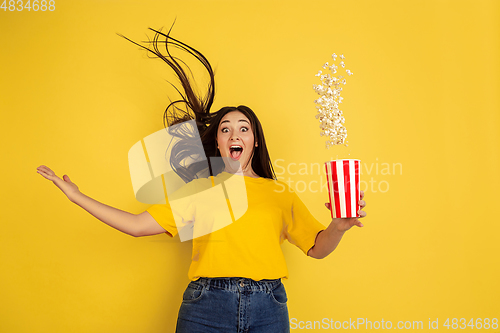 Image of Caucasian woman\'s portrait isolated on yellow studio background