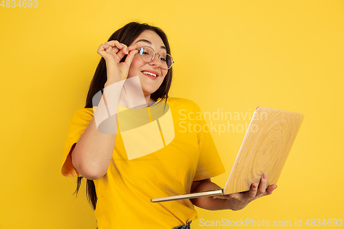 Image of Caucasian woman\'s portrait isolated on yellow studio background