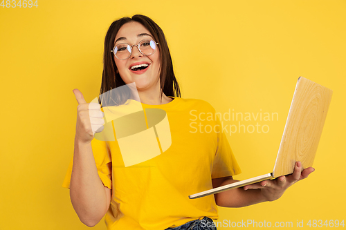 Image of Caucasian woman\'s portrait isolated on yellow studio background