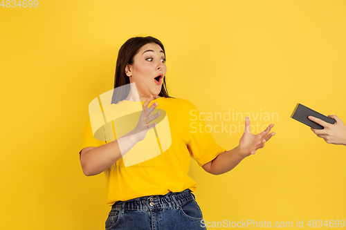 Image of Caucasian woman\'s portrait isolated on yellow studio background