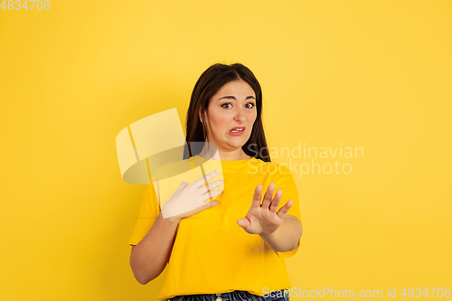 Image of Caucasian woman\'s portrait isolated on yellow studio background