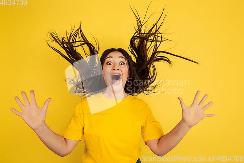 Image of Caucasian woman\'s portrait isolated on yellow studio background