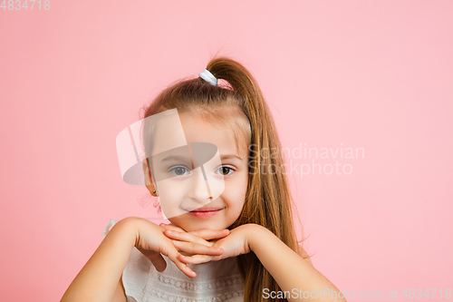 Image of Pretty caucasian girl portrait isolated on pink studio background with copyspace