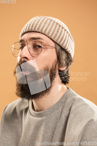 Image of Portrait of Caucasian man in glasses and hat isolated on light background.