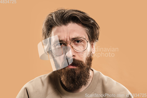 Image of Half-length portrait of Caucasian man isolated over light yellow background.