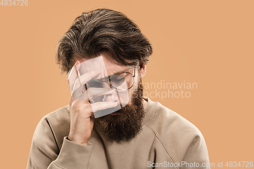 Image of Half-length portrait of Caucasian man isolated over light yellow background.